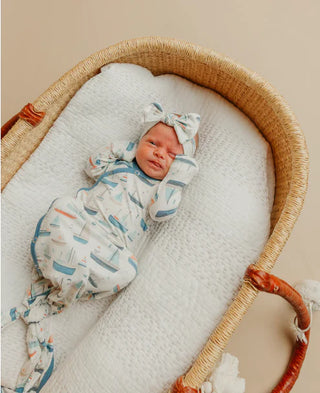 Newborn baby in a woven bassinet with a soft blanket