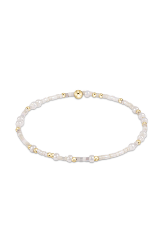 Pearl bracelet with gold beads on a white background