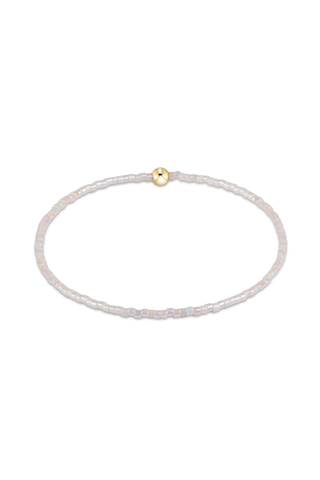 Delicate bracelet with a gold bead on a white background
