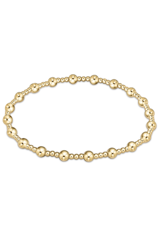 Gold beaded bracelet on a white background