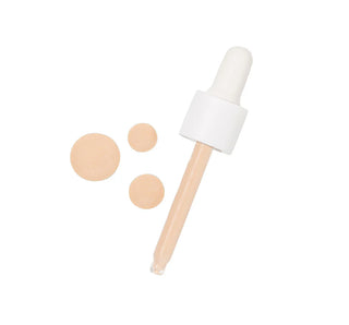 Foundation dropper with beige samples on a white background