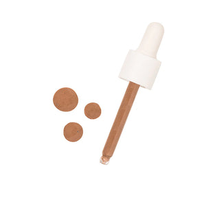 Cosmetic applicator with brown handle and white cap on a white background