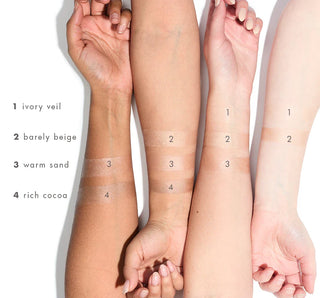 Hands and arms showing different makeup color swatches on a white background