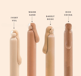 Set of four cosmetic applicators labeled with color names on a beige background