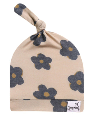 Beige baby hat with floral pattern and 'Copper Pearl' label on a white background