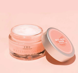 Jar of 'Farmhouse Fresh' watermelon facial serum on a pink background