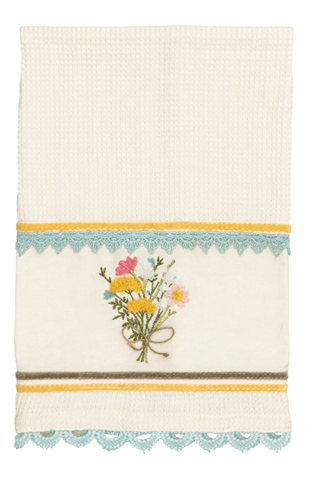 Decorative towel with floral design and colorful border on a white background