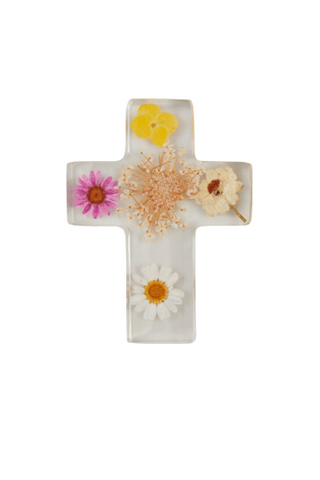 Decorative cross with pressed flowers on a white background