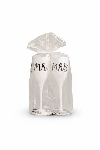 White Acrylic Champagne flutes with Mr. & Mrs. written on them in Plastic on a white background