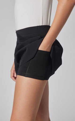 Black shorts worn by a person on a plain background