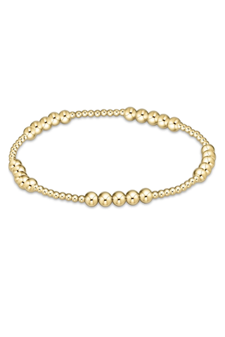 Gold beaded bracelet on a white background