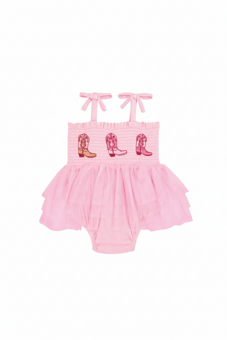Pink romper with cowboy boot designs on a white background