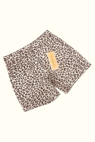 Leopard print shorts with a visible brand tag on a white background
