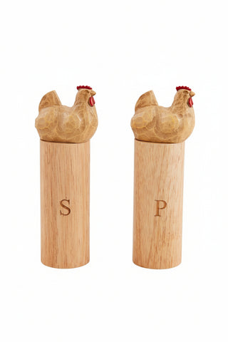 wooden chicken salt and pepper grinders on white background.