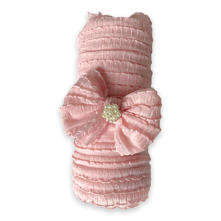 Pink pet dress with a large bow and decorative element on a white background