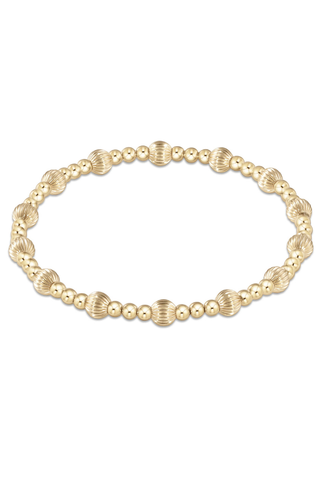 gold beaded bracelet on white background