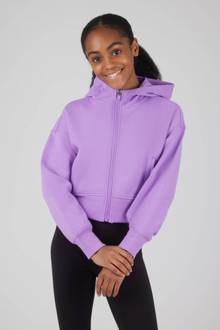 Person wearing a purple hoodie on a plain background