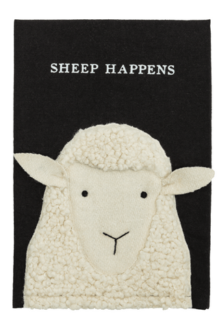 White sheep plush toy with 'Sheep Happens' text on a black background
