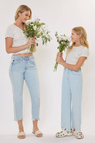 Two women holding flowers against a white background