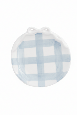 Round ceramic plate with blue and white checkered pattern on a white background