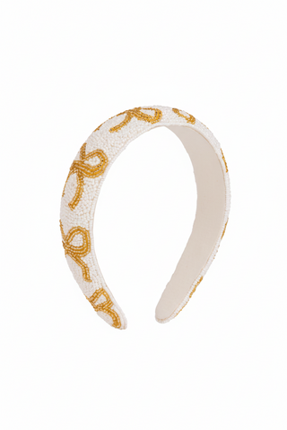 Beige headband with gold decorative elements on a white background