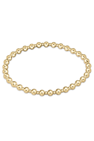 Gold beaded bracelet on a white background