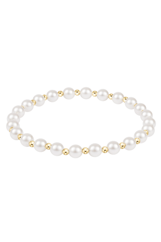 Pearl bracelet with gold accents on a white background