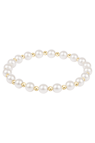 Pearl bracelet with gold beads on a white background