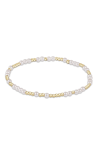 Pearl bracelet with gold accents on a white background