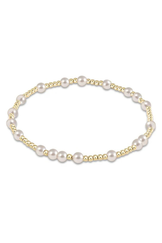 Pearl bracelet with gold accents on a white background