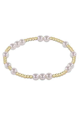 Gold and pearl beaded bracelet on a white background