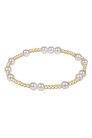 Pearl bracelet with gold accents on a white background
