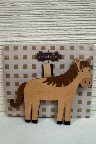 Horse wood chip clip on striped cardstock in front of a wooden wall