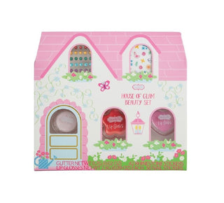 House-shaped beauty set packaging with pink roof and colorful doors on a white background