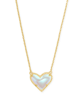 Gold necklace with a heart-shaped pendant on a white background