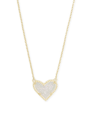Heart-shaped pendant necklace with gold chain on a white background