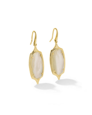 A pair of gold drop earrings with irregular marquise-shaped milky white mother-of-pearl inlays, shown on a clean white background with soft shadows.