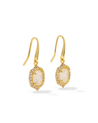 A pair of gold drop earrings featuring oval milky white opal-like center stones surrounded by small clear pavé stones, suspended from gold French hooks on a white background.