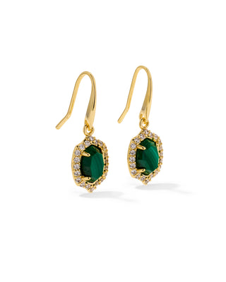 A pair of gold drop earrings featuring oval-cut emerald green gemstones surrounded by a halo of small clear stones, shown on a clean white background.