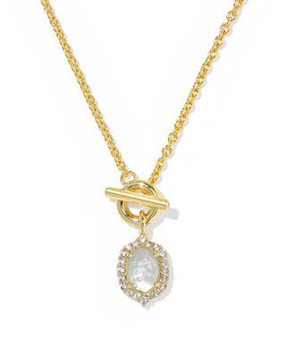 A gold chain necklace with a toggle clasp and a teardrop-shaped pendant featuring a white mother-of-pearl center stone surrounded by small clear stones, shown on a white background.