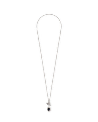 A delicate silver chain necklace with a small bird pendant holding a single round black gemstone, displayed against a solid white background.