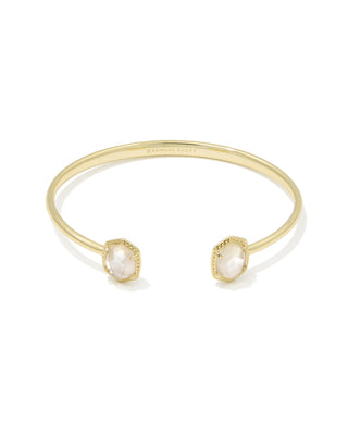 Gold bracelet with pearl-like stones on a white background