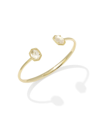 Gold bracelet with two gemstones on a white background