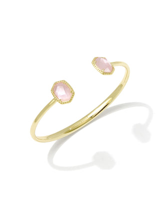 Gold bracelet with pink stones on a white background