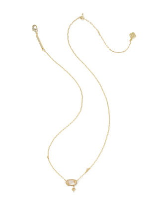A delicate gold chain necklace with a small rectangular clear gemstone pendant and a tiny dangling charm, displayed on a solid white background.