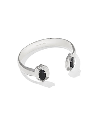 A sterling silver cuff bracelet with two shield-shaped settings holding small oval black stones, shown on a clean white background.