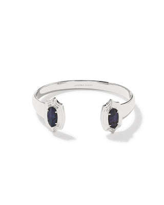 A silver cuff bracelet with two open ends, each featuring a dark oval gemstone in a decorative setting, shown on a white background.