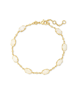 Gold bracelet with white stones on a white background