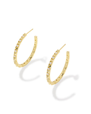 A pair of gold hoop earrings with small clear stones set along the front, displayed on a clean white background with soft shadows.