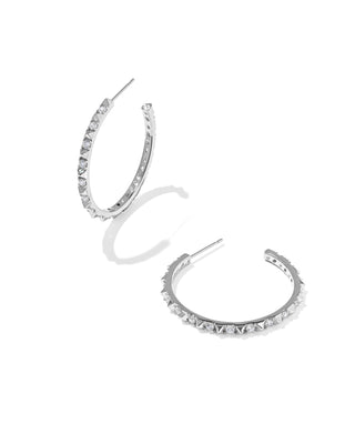 A pair of silver-toned open hoop earrings embellished with small clear stones, shown on a clean white background.